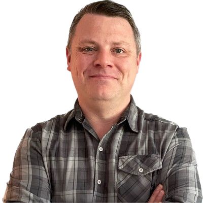 Jeff Sironi smiling, arms crossed, in a gray plaid shirt